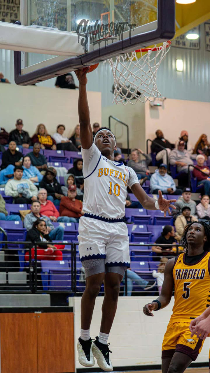 Donte Lott | Buffalo High School Basketball | Class of 2027 Donte Lott of Buffalo High School finishes at the basket during a Texas high school basketball game.