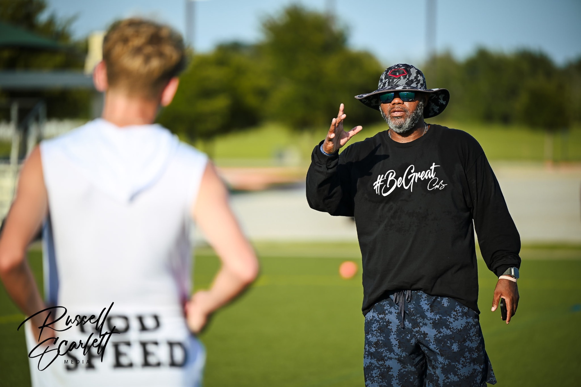 Coach Chris Taylor instructing an athlete during a sports performance training session
